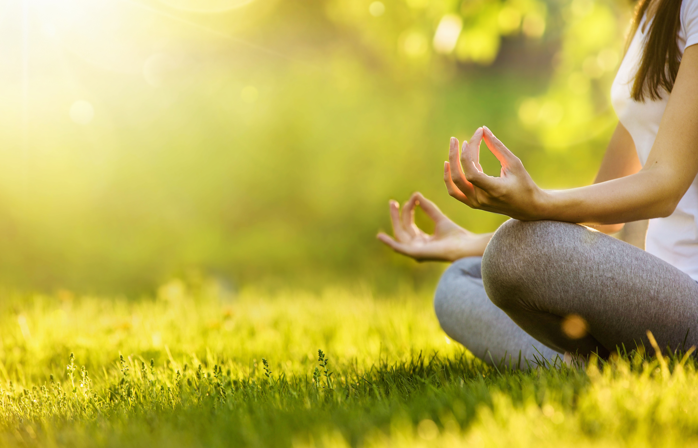 Yoga woman meditating at sunset